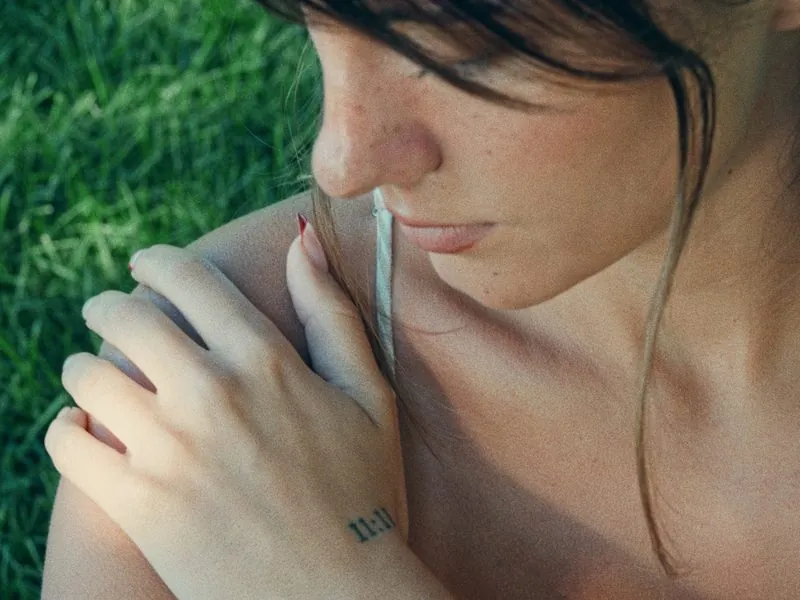 A hand on a bare shoulder, eyes closed, from Thank You, Summer, an Aesop concept film by Studio Propel