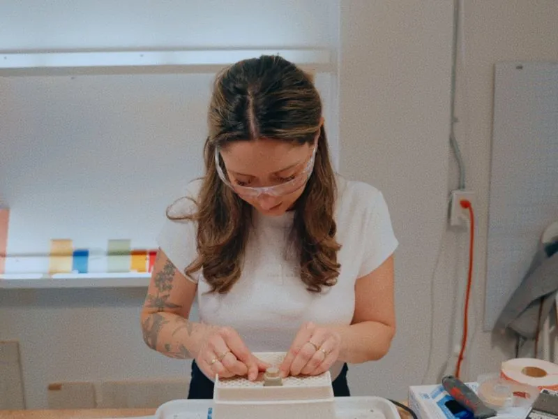 Kristie Urbanski at work in safety glasses in her Toronto studio, from Art and Motherhood by Studio Propel