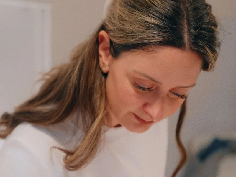 A close portrait, eyes down on the work, from Art and Motherhood by Studio Propel