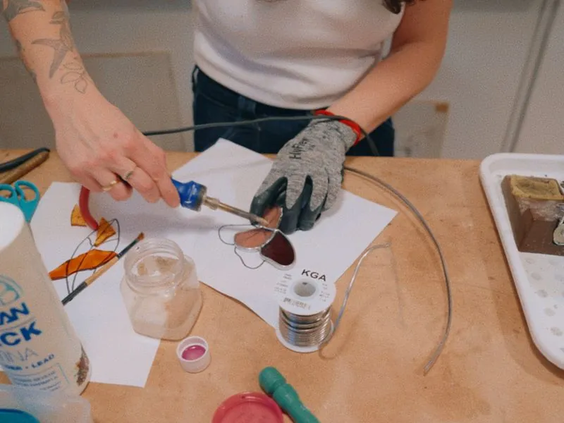 Soldering a small stained glass heart, from Art and Motherhood by Studio Propel