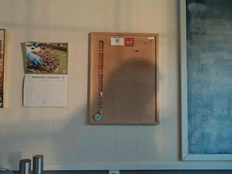 A cork board in the kitchen, September on the calendar, from First Day, a Studio Propel short film