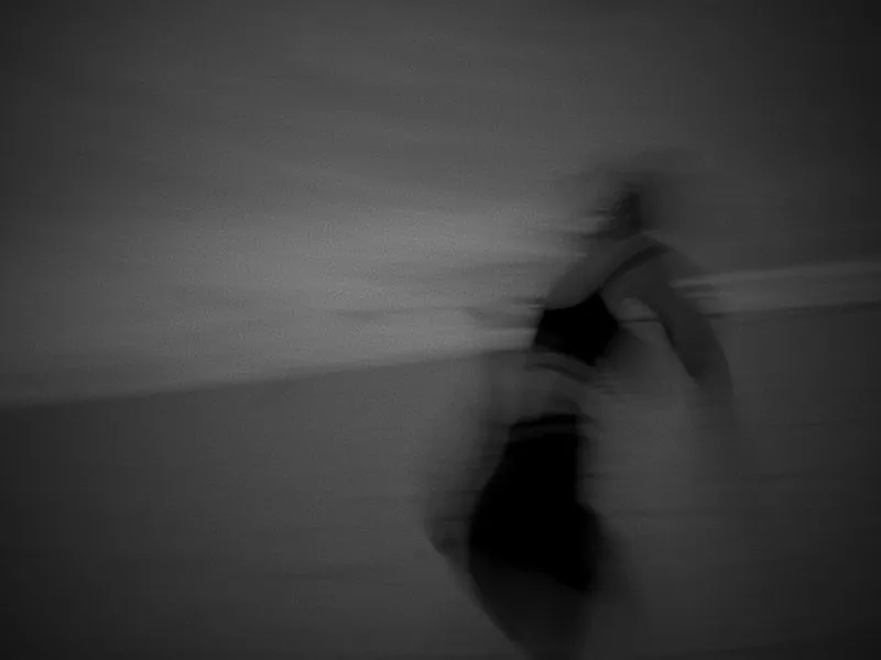 A runner blurred in motion, in black and white, from Infinite Horizon, a New Balance concept film by Studio Propel