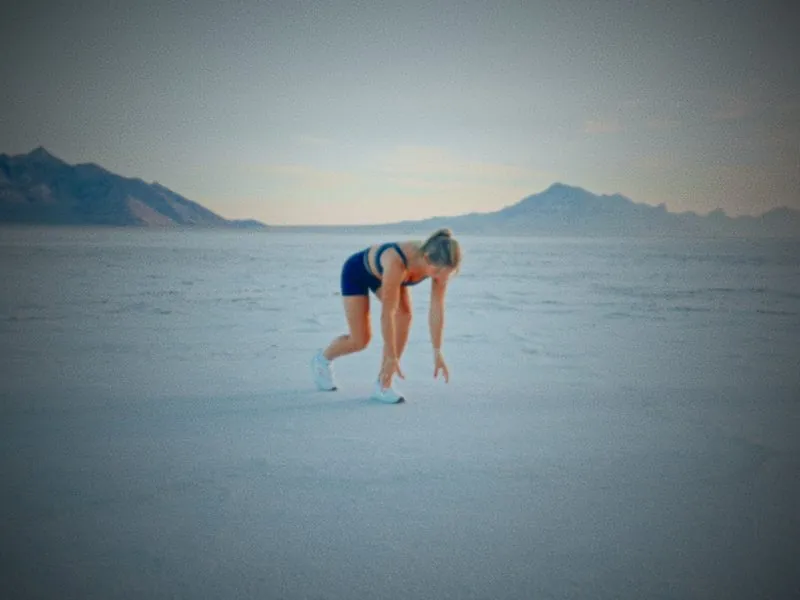 A runner in a starting crouch on the open salt flats, from Infinite Horizon, a New Balance concept film by Studio Propel