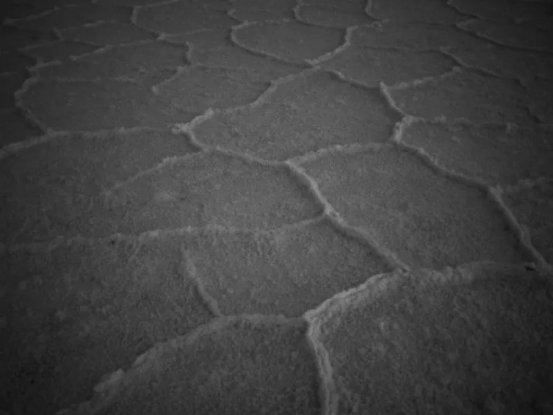 Salt crust patterns underfoot, in black and white, from Infinite Horizon, a New Balance concept film by Studio Propel