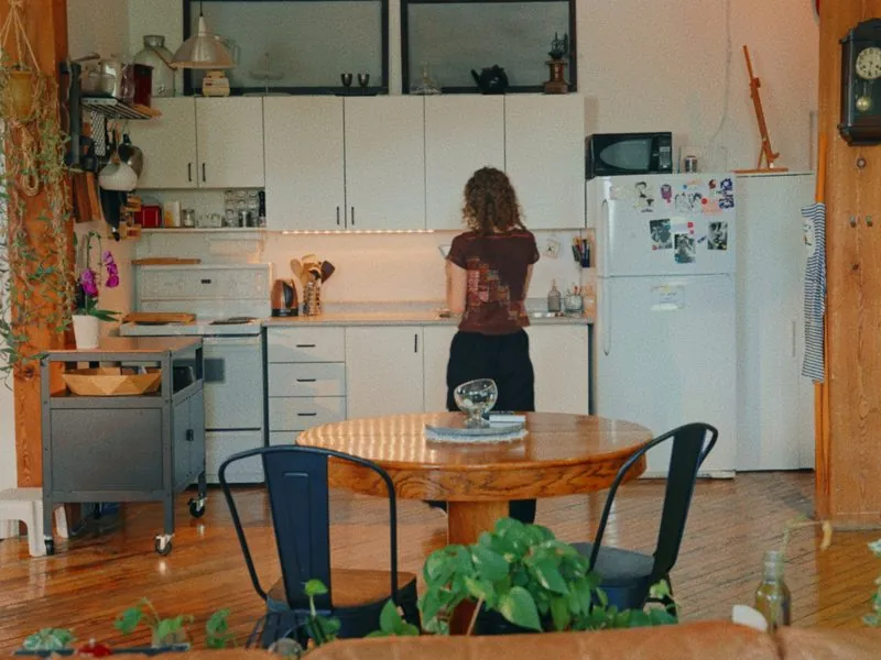 Reading at the kitchen counter in a sunlit loft, from Curiouser, a Rakuten Kobo concept film by Studio Propel