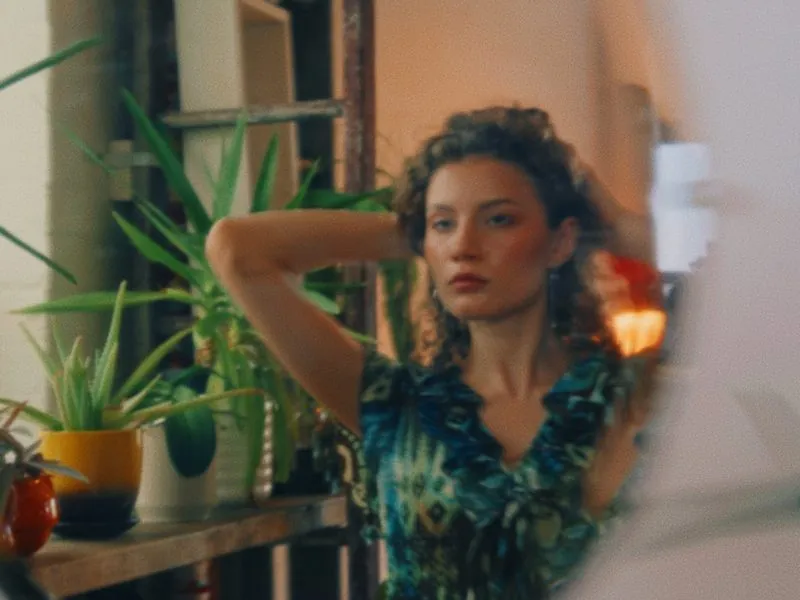 A reflection in a round mirror among the plants, from Curiouser, a Rakuten Kobo concept film by Studio Propel
