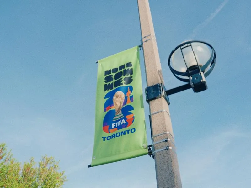 A FIFA World Cup 2026 Toronto banner on a lamp post, from Something Is Coming by Studio Propel