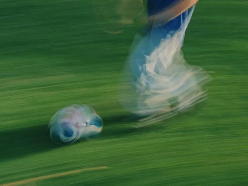 A ball moving fast across the grass, from Something Is Coming by Studio Propel