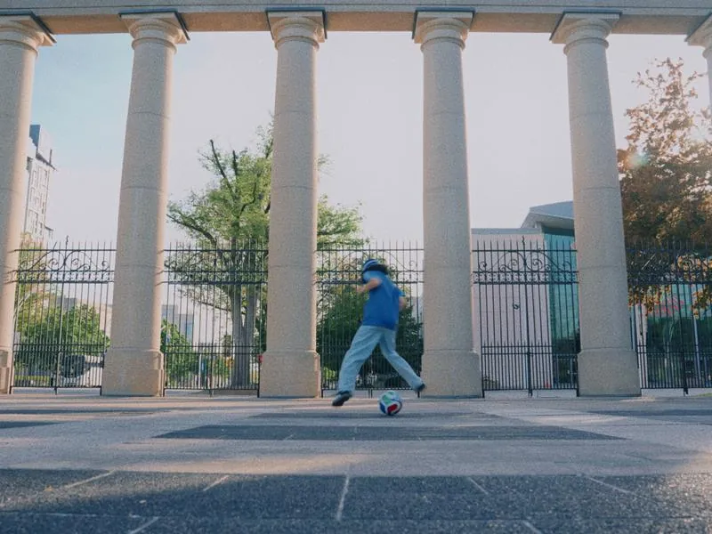 A kick between the columns of the Princes' Gates, from Something Is Coming by Studio Propel
