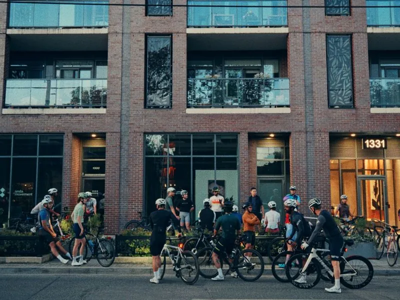 Riders gathering outside the ÜNDA store before sunrise, from Morning Ride, an ÜNDA Movement brand film by Studio Propel