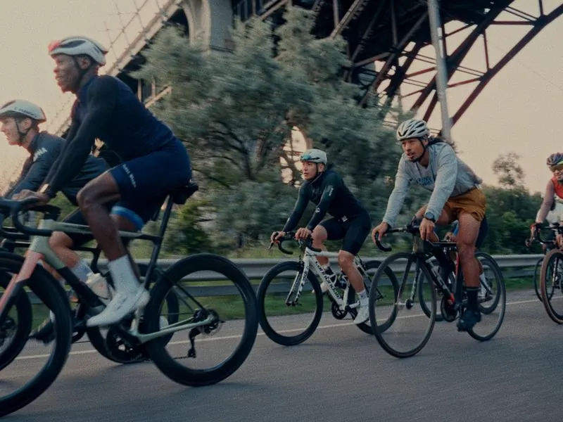 The group riding together under the bridge, from Morning Ride, an ÜNDA Movement brand film by Studio Propel